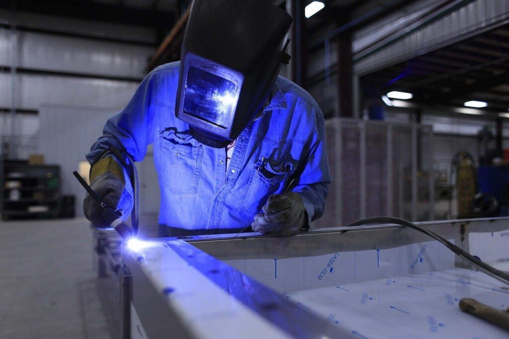Welder working with a welding helmet.